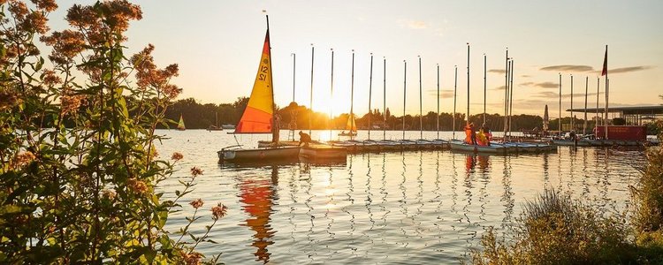 Segelboote auf einem See bei Sonnenuntergang